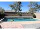 In-ground swimming pool featuring a waterfall edge, pool toys, and desert landscaping at 8420 S 40Th Dr, Laveen, AZ 85339