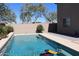 Swimming pool with a stone wall in a desert backyard setting at 8420 S 40Th Dr, Laveen, AZ 85339