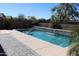 Backyard pool surrounded by desert landscaping and houses at 8420 S 40Th Dr, Laveen, AZ 85339