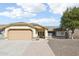 Charming single-story home featuring a two-car garage and a well-manicured front yard, with desert landscaping at 8562 W Windsor Blvd, Glendale, AZ 85305