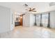 Primary bedroom with tile flooring, ensuite bathroom access, and a ceiling fan at 8562 W Windsor Blvd, Glendale, AZ 85305