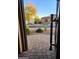 View of the manicured front yard and exterior of the home through the open gate at 8928 E Wethersfield Rd, Scottsdale, AZ 85260