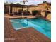 Beautiful pool featuring a waterfall, pergola, and dining set for a relaxing backyard experience at 8928 E Wethersfield Rd, Scottsdale, AZ 85260