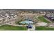 Aerial view of community featuring a pool, playground, and green spaces at 9008 W Bethany Heights Dr, Glendale, AZ 85305