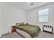 Bright bedroom features a neutral palette and large window for natural light at 9008 W Bethany Heights Dr, Glendale, AZ 85305