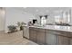 Modern kitchen with stainless steel appliances and a large kitchen island looking into the cozy living space at 9008 W Bethany Heights Dr, Glendale, AZ 85305