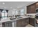 Modern, open-concept kitchen featuring stainless steel appliances and seamless flow into the living area at 9008 W Bethany Heights Dr, Glendale, AZ 85305