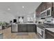 Modern kitchen featuring stainless steel appliances and a large island that looks to seamlessly flows into the living area at 9008 W Bethany Heights Dr, Glendale, AZ 85305