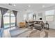 Bright living room with a comfortable gray sofa, modern rug, and sliding glass doors to the outdoor space at 9008 W Bethany Heights Dr, Glendale, AZ 85305