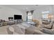 Open-concept living room with a gray sofa, a beanbag chair, and a flat-screen TV at 9008 W Bethany Heights Dr, Glendale, AZ 85305