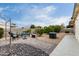 Spacious backyard featuring decorative gravel, paver patio, and well-maintained landscaping at 9340 E Sun Lakes S Blvd, Sun Lakes, AZ 85248