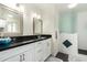 Well-lit bathroom featuring dual mirrors, sleek countertops, white cabinets, modern lighting, and a tiled walk-in shower at 9340 E Sun Lakes S Blvd, Sun Lakes, AZ 85248