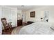 Spacious bedroom with wood floors, a rocking chair, and a view of the ensuite bathroom at 9340 E Sun Lakes S Blvd, Sun Lakes, AZ 85248