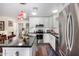 Bright open kitchen with stainless steel appliances, white cabinetry, dark countertops, and a view of the breakfast nook at 9340 E Sun Lakes S Blvd, Sun Lakes, AZ 85248