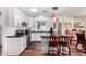 Bright kitchen with stainless steel appliances, white cabinetry, and dark countertops and a view of a breakfast nook at 9340 E Sun Lakes S Blvd, Sun Lakes, AZ 85248