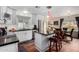 Bright eat-in kitchen with stainless steel appliances, white cabinetry, dark countertops, pendant lights, and adjacent dining area at 9340 E Sun Lakes S Blvd, Sun Lakes, AZ 85248