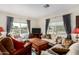 Comfortable living room featuring hardwood floors, a wooden coffee table, and large windows at 9340 E Sun Lakes S Blvd, Sun Lakes, AZ 85248