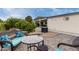 Inviting patio with mosaic table, wicker furniture, mature citrus trees, and covered porch at 9340 E Sun Lakes S Blvd, Sun Lakes, AZ 85248