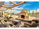 Relaxing outdoor patio with a stone fireplace and comfortable seating area for enjoying time with friends and Gathering at 9340 E Sun Lakes S Blvd, Sun Lakes, AZ 85248