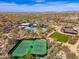 Aerial view of tennis courts, pool, and clubhouse, showcasing the community's recreational amenities at 9565 E Mountain Spring Rd, Scottsdale, AZ 85255