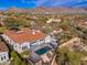 Expansive aerial view of a private backyard with pool, manicured landscaping, and outdoor entertaining space at 9565 E Mountain Spring Rd, Scottsdale, AZ 85255