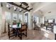 Dining area with beamed ceilings, wood table, and chairs, and a view of the surrounding landscape through shuttered windows at 9565 E Mountain Spring Rd, Scottsdale, AZ 85255