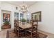 Elegant dining room with a wooden table, chandelier, and ample natural light at 9565 E Mountain Spring Rd, Scottsdale, AZ 85255