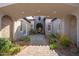 Beautiful home showcasing a paved walkway leading to a covered front entrance and manicured landscaping at 9565 E Mountain Spring Rd, Scottsdale, AZ 85255