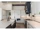 Modern kitchen design with white cabinetry, black accents, and a sleek stainless steel range and hood at 9565 E Mountain Spring Rd, Scottsdale, AZ 85255