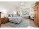 Spacious bedroom with a tufted headboard, sitting area, and large windows at 9565 E Mountain Spring Rd, Scottsdale, AZ 85255