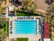 Aerial view of a community pool with many lounge chairs and nearby basketball and pickleball courts at 9565 E Mountain Spring Rd, Scottsdale, AZ 85255