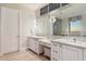 Beautiful bathroom featuring dual sinks, a vanity area, decorative mirrors, and a neutral color scheme at 9820 E Thompson Peak Pkwy # 629, Scottsdale, AZ 85255