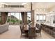 Bright dining room boasts mountain views, stone accent wall, and modern chandelier at 9820 E Thompson Peak Pkwy # 629, Scottsdale, AZ 85255