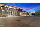 Striking exterior showing motor court with stone accents, complemented by desert landscape at 9820 E Thompson Peak Pkwy # 629, Scottsdale, AZ 85255