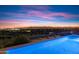 Nighttime view of the pool with an expansive view of the city lights in the distance at 9820 E Thompson Peak Pkwy # 629, Scottsdale, AZ 85255