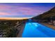 Tranquil pool area illuminated at twilight, offering picturesque views of the cityscape at 9820 E Thompson Peak Pkwy # 629, Scottsdale, AZ 85255