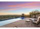 Relaxing pool and lounge area with panoramic views of the valley at dusk at 9820 E Thompson Peak Pkwy # 629, Scottsdale, AZ 85255