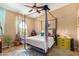 Beautiful bedroom featuring a four poster bed frame and a view to the outside at 10136 E Southern Ave # 3065, Mesa, AZ 85209