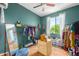 Charming bedroom featuring turquoise walls, a ceiling fan, and a view to the outside at 10136 E Southern Ave # 3065, Mesa, AZ 85209
