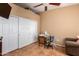 Neutral-toned bedroom featuring a large closet space, a desk, and a comfortable chair at 10136 E Southern Ave # 3065, Mesa, AZ 85209