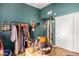 Stylish bedroom featuring turquoise walls, jewelry, and a clothing rack for maximum storage at 10136 E Southern Ave # 3065, Mesa, AZ 85209