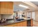 Open-concept kitchen with wood cabinets, granite countertops, and stainless steel appliances at 10136 E Southern Ave # 3065, Mesa, AZ 85209