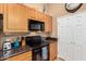 Functional kitchen featuring wood cabinets, black appliances, and ample counter space at 10136 E Southern Ave # 3065, Mesa, AZ 85209