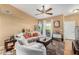 Comfortable living room with a ceiling fan, sliding glass doors, and neutral decor at 10136 E Southern Ave # 3065, Mesa, AZ 85209