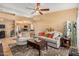 Open-concept living room with adjacent kitchen, tile flooring, and comfortable seating at 10136 E Southern Ave # 3065, Mesa, AZ 85209