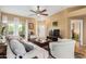 Cozy living room features tile floors, a ceiling fan, and a sliding door to the outside at 10136 E Southern Ave # 3065, Mesa, AZ 85209