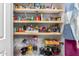 Well-organized pantry with wooden shelves stocked with various food items and kitchen essentials at 10136 E Southern Ave # 3065, Mesa, AZ 85209