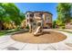 Community playground featuring a slide, climbing structures, and a wood chip surface for safety at 10136 E Southern Ave # 3065, Mesa, AZ 85209