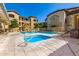 Community pool featuring a spa, lounge seating, and views of the surrounding apartment buildings at 10136 E Southern Ave # 3065, Mesa, AZ 85209