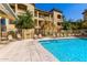 Bright and inviting community pool with lounge chairs, surrounded by well-maintained apartment buildings at 10136 E Southern Ave # 3065, Mesa, AZ 85209